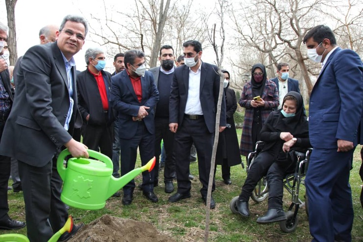 شهردار مشهد در کنار افراد دارای معلولیت و توان‌یابان گل و نهال کاشت