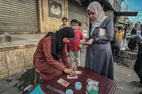 گزارش تصویری | زن فلسطینی با ترمیم اسکناس‌های پاره امرار معاش می‌کند