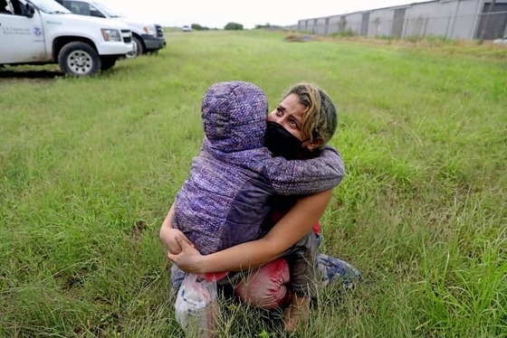 مایلیدی بارلا، ۲۶ ساله، اهل تگوسیگالپا در هندوراس، دخترش زوئه بارلا، ۸ ساله، را در لا جویا در تگزاس در آغوش می گیرد. این دو به طور غیرقانونی از مرز ایالات متحده و مکزیک عبور کردند و منتظر ماندند تا توسط گمرک و حفاظت مرزی ایالات متحده به وضعیتشان رسیدگی شود. (گری کورونادو)