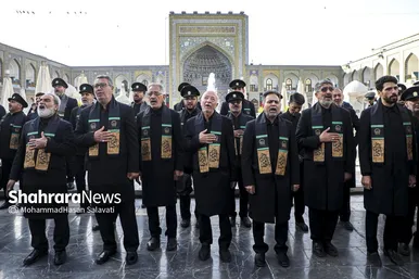 خادمان در حال اذن گرفتن از امام رضا(ع) برای شروع این آیین هستند
