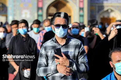 اهتزاز پرچم عزای حسینی بر فراز گنبد حرم رضوی